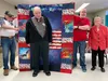 Presenting Mr. Hartvigson’s certificate is WWII Navy veteran, Elverda Lincoln. Displaying the quilt are Vietnam Air Force veteran Jim Woodley [left] and post-Vietnam Army veteran Jerry Killio