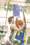 ROBERT DeBERRY/Frontiersman Colony senior Jaron Murphy tries to
bring the ball up to the basket, but Kodiak forward Jon Bryant
stuffs his attempt during the second half of the Knights’ 47-43 