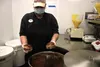 Athena Barnes demonstrates who to add the chocolate to the donut at the Wasilla store. Barnes is one of the company's trainers. Tim Rockey/Frontiersman