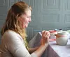 Lori Berrigan paints a pot at NuKreationz Art and Creativity Center in preparation for a Raku firing. JENNY WEAVER
For the Frontiersman