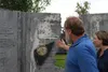 Tim Rockey/FrontiersmanMike Sweeney and his family looks at broken concrete that use to bear the names of U.S. soldiers at the Veteran’s Wall of Honor.