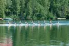 ROBERT DeBERRY/Frontiersman The Anchorage Rowing Association
eight-woman team crosses the finish line during Saturday’s Moose
Nugget Regatta on Wasilla Lake.