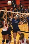 Palmer senior Megan Meekin attempts to tip the ball over Wasilla
senior Kristen Lenius during the first game of the Warriors' 3-1
win over ther Moose Tuesday. Photo by JEREMIAH
BARTZ/Frontier