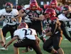 Houston running back Ben Pelesasa runs the ball into traffic during a loss to Eielson earlier this season. Pelesasa and the Hawks host Barrow in a key Aurora Conference game Saturday at 7 p.m