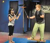 Karo Germain spins plates with Aiden Jolley while balancing on a rola-bola during a 2011 performance of the Green Light Circus. Talkeetna’s newest circus stars will spotlight their new skills