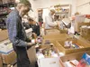 Linnus Depriest and Dennis Moore sort through donated food at the Palmer Food Bank Thursday afternoon. ROBERT DeBERRY/Frontiersman.com