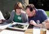 Phto courtesy Alaska Agriculture in the Classroom Polly Rowell,
left, recently awarded a scholarship to attend a national
conference on agricultural literacy, examines macroinvertebrates
coll