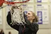 Wasilla senior Kellie Lindeman cuts down a piece of the net as the Warriors celebrate their 49-35 win over Colony in the Northern Lights Conference title game March 12, 2016, in Palmer. JEREM