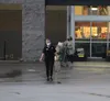 Customers at the Wasilla Fred Meyer leave the store Wednesday evening. Fred Meyer's parent company, Kroger, has issued a requirement that customers must wear masks while in the store. Jacob M