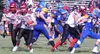 Houston’s Owen Mulhaney (82) runs past Monroe Catholic’s Xavier Stinger-Siania (64), Michael Johnson (68) and Harley Morris (74) during the first half of Saturday’s nonconference Division III