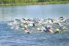 TODD L. DISHER/Frontiersman A pack of swimmers churn across Big
Lake on Sunday for the second leg of the local triathlon.