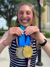 Gretchen Winter shows off her medals at the Special Olympics USA Games, held in Orlando, Fla., in June 2022. Next stop for the 30-year runner from Palmer is Berlin, Germany, in June, for the 