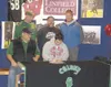 GREG JOHNSON/Frontiersman Seated next to his father, Richard
Farber, Colony senior Trey Farber signs his National Letter of
Intent to play football for Division III power Linfield College at
