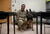 U.S. Air Force Master Sgt. Adele Dailey, 354th Medical Group flight chief, poses for a photo with Jocky, retired military working dog during a K-9 Tactical Combat Casualty Care course at Fort