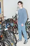 Adam Berg stands with the 18 bikes he has collected for the
Special Santa program. Photo by CASEY RESSLER/Frontiersman.