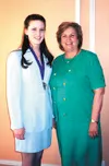 Wasilla 14-year-old Kimberly Carr accepts her award from First
Lady Nancy Murkowski. One other Valley resident, Sharon Kern, also
received a First Lady Volunteer of the Year award.Submitted
p