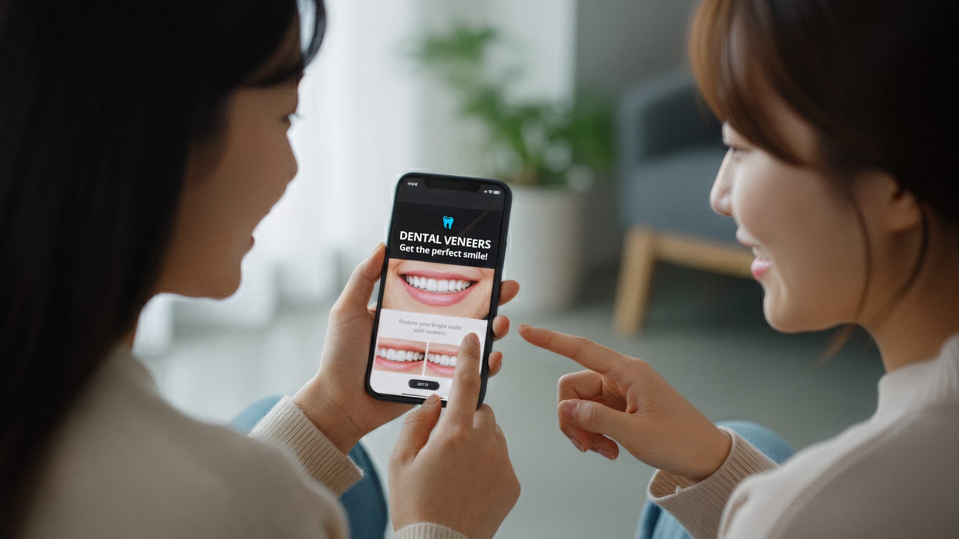 A woman patient in her early 30s talking with a friend while looking at a mobile screen showing laminate costs and advertisements