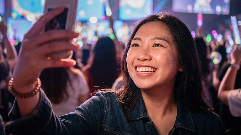 Depiction of a patient happily enjoying daily life after a dental veneer procedure.