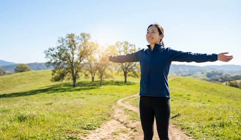 Energetic person outdoors, symbolizing a restored quality of life after treatment.