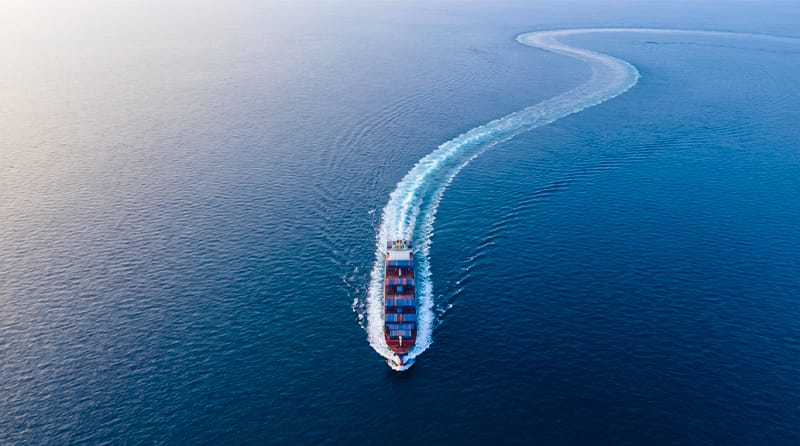 Aerial view of a massive cargo ship turning slowly, representing the gradual change in TSH levels.