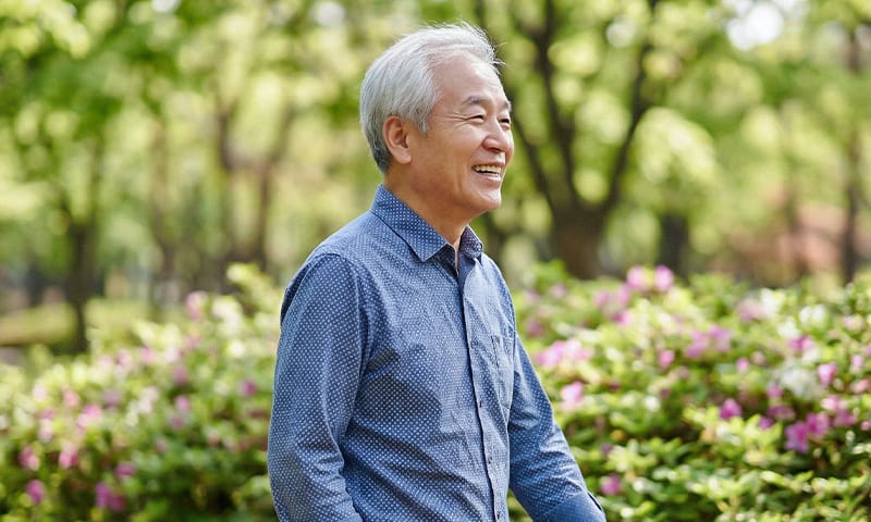 A happy elderly person enjoying a walk outdoors