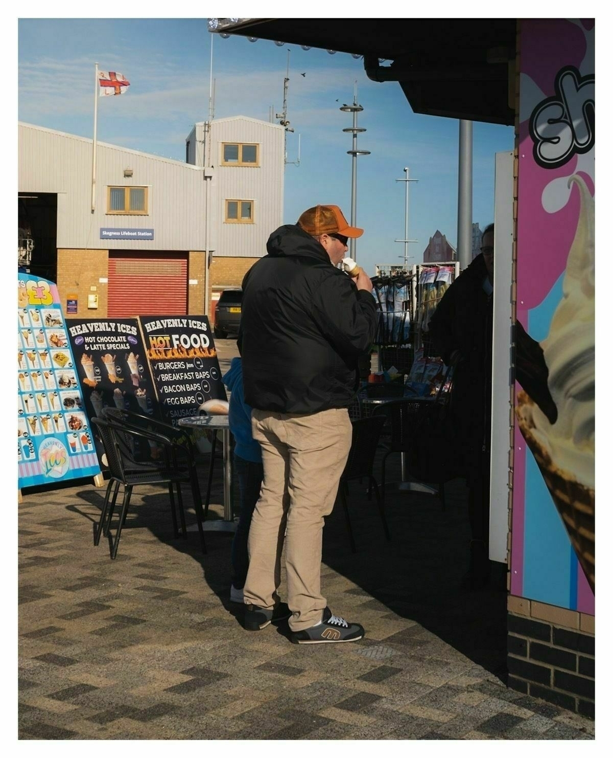 Man eating ice cream in a winter jacket