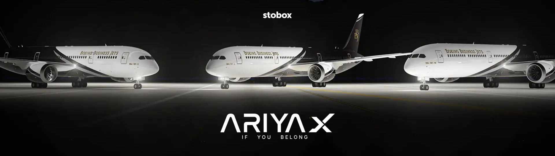 Three white Boeing Business Jets aircraft in hangar with Ariyax branding.