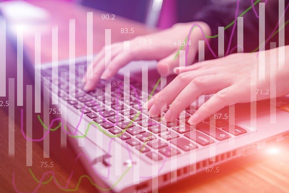 A growth chart with a woman writing on a keyboard in the background- SMEs financing