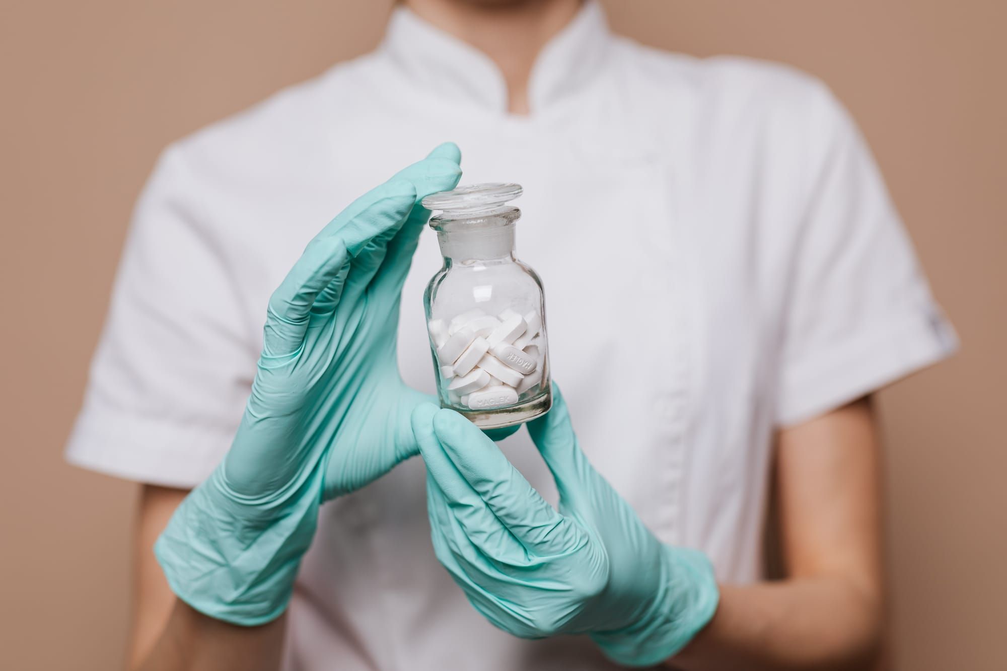 A woman holding a bottle of pills drug development