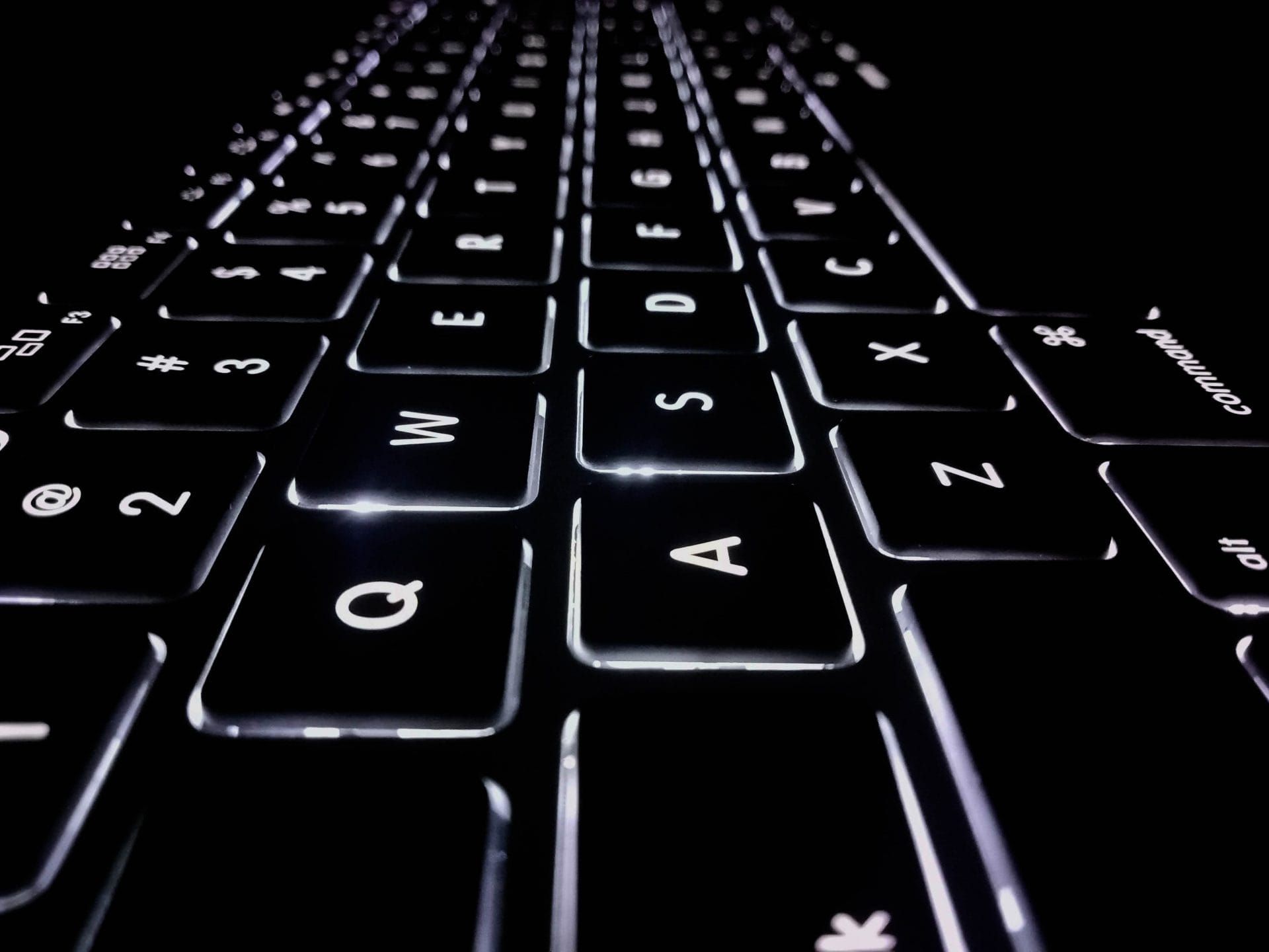 A close up into an illuminated computer keyboard; cybersecurity