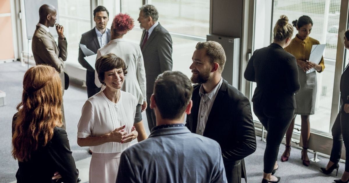 people talking to each other at a conference
