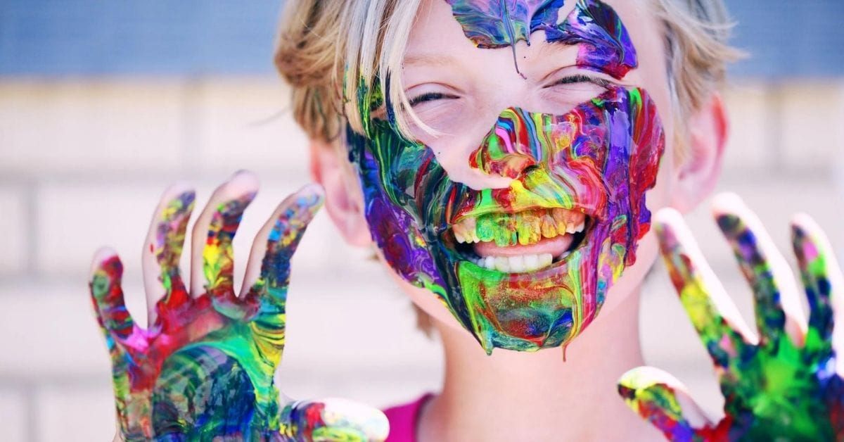 a kid with paint on his hands