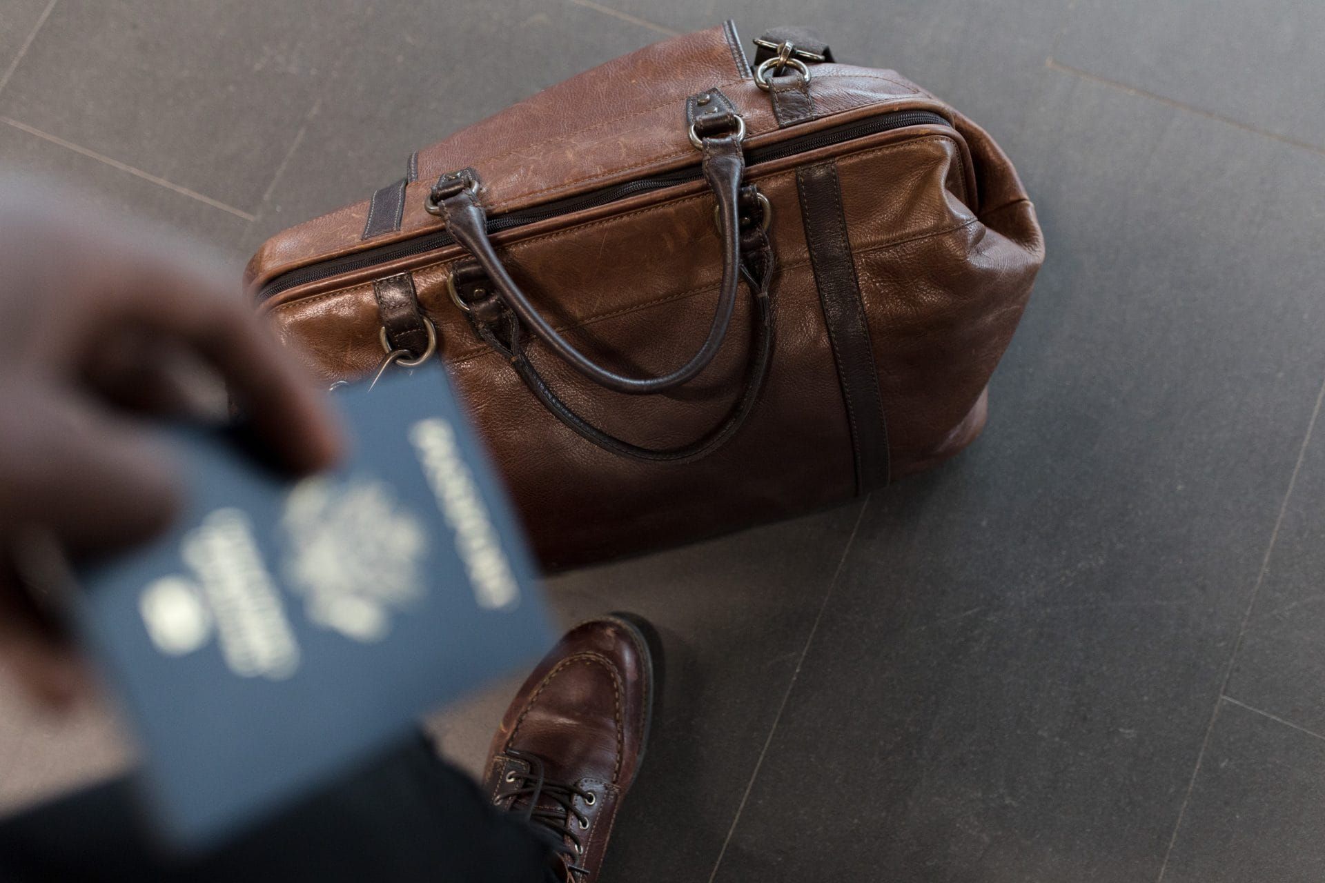 A man holding a passport next to a travel bag, Bulgarian startup visa