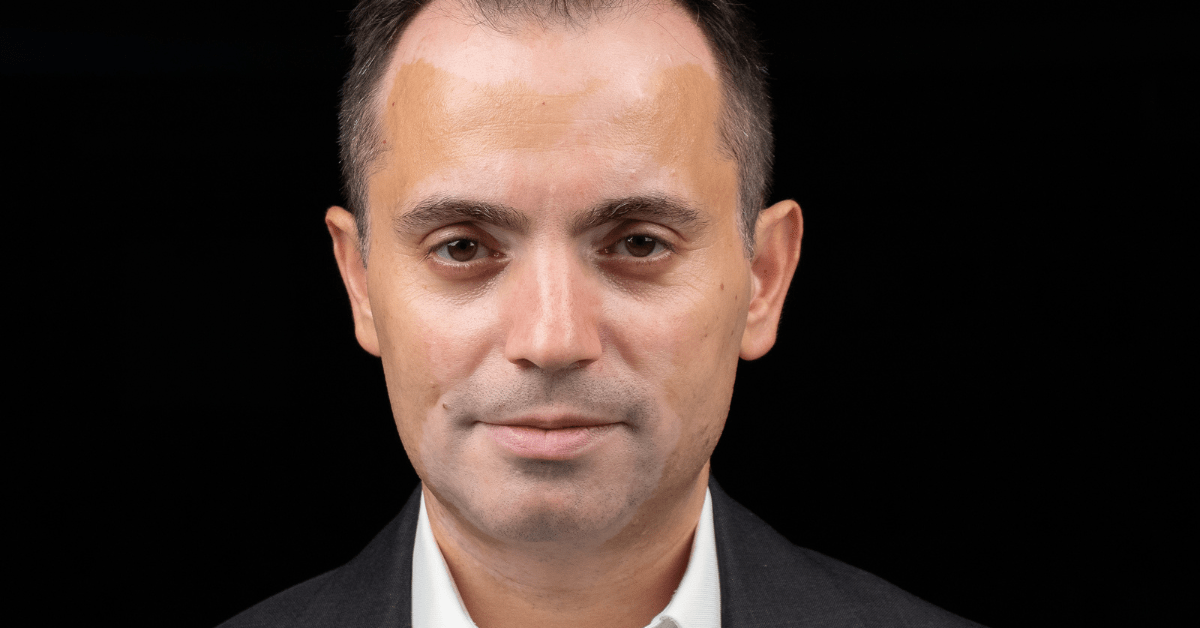 A portrait photo of Elvin Guri on a black bacground