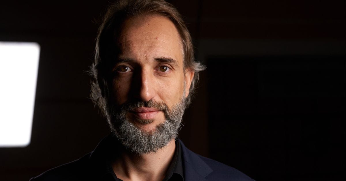 A portrait picture of the CEO of Digital Lights Dimitar Dimitrov on a black background with a light on the left corner