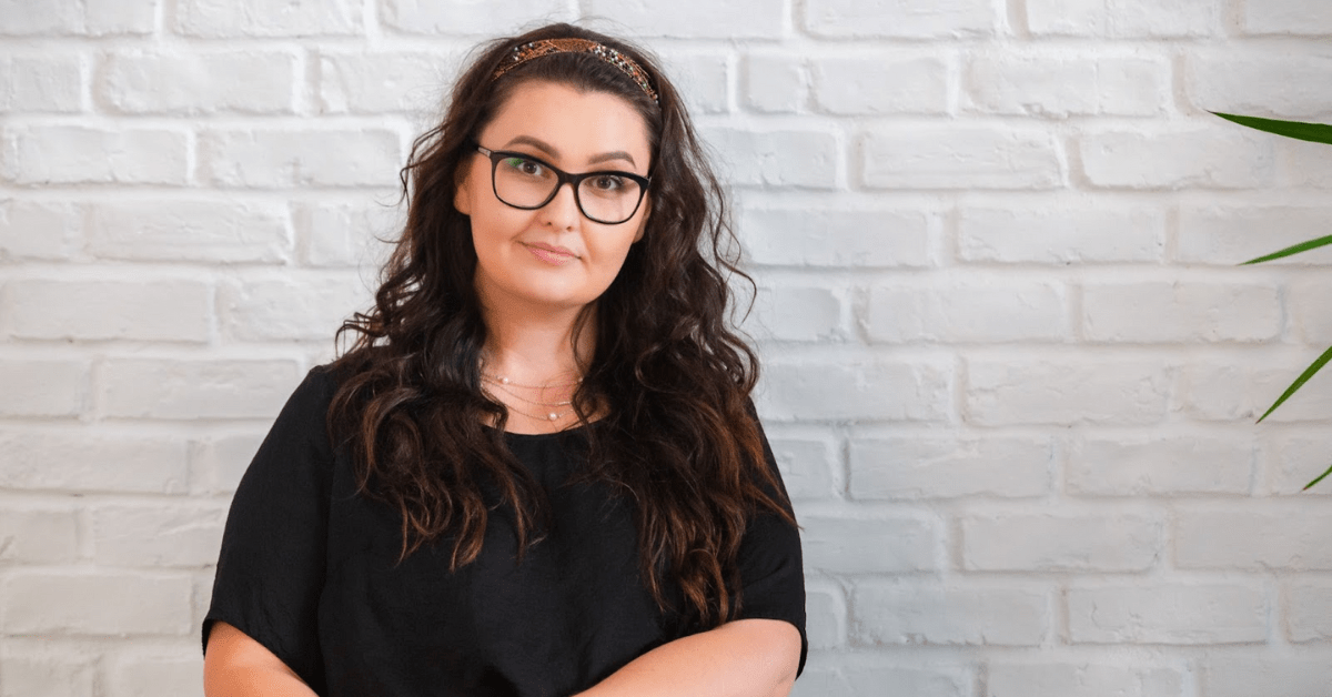 A portrait picture of Andra Pintican on a white background, she talks about how to improve PR