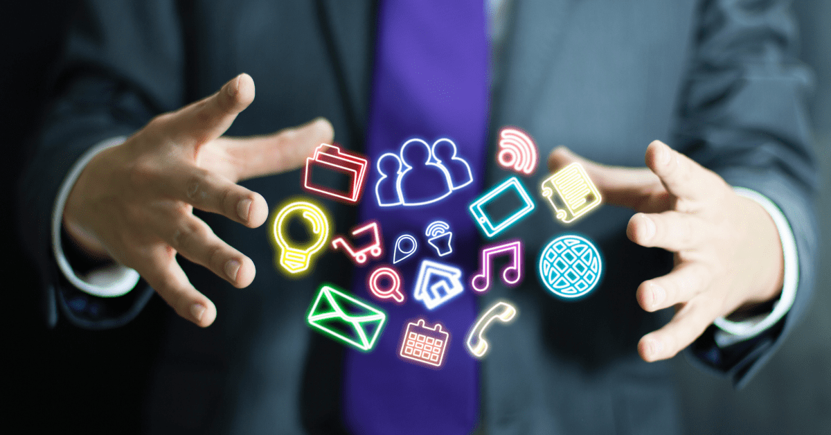 Closeup of a man's hands with digital apps icons in between them.