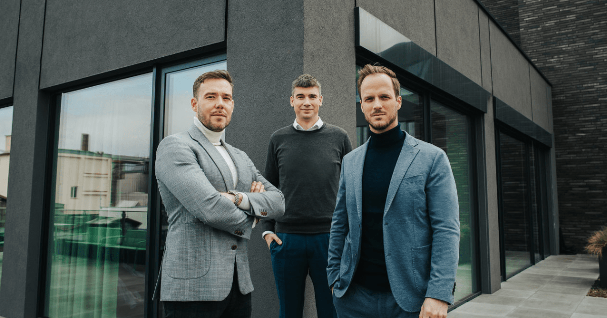 Three men in front of a building