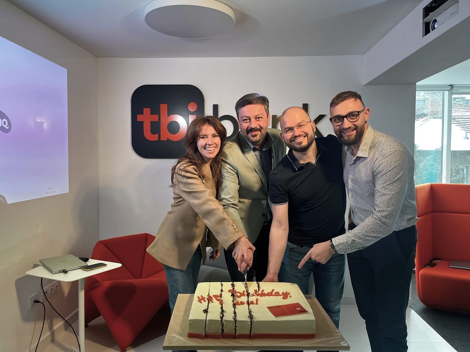 the tbi neon team celebrating the first birthday of the product