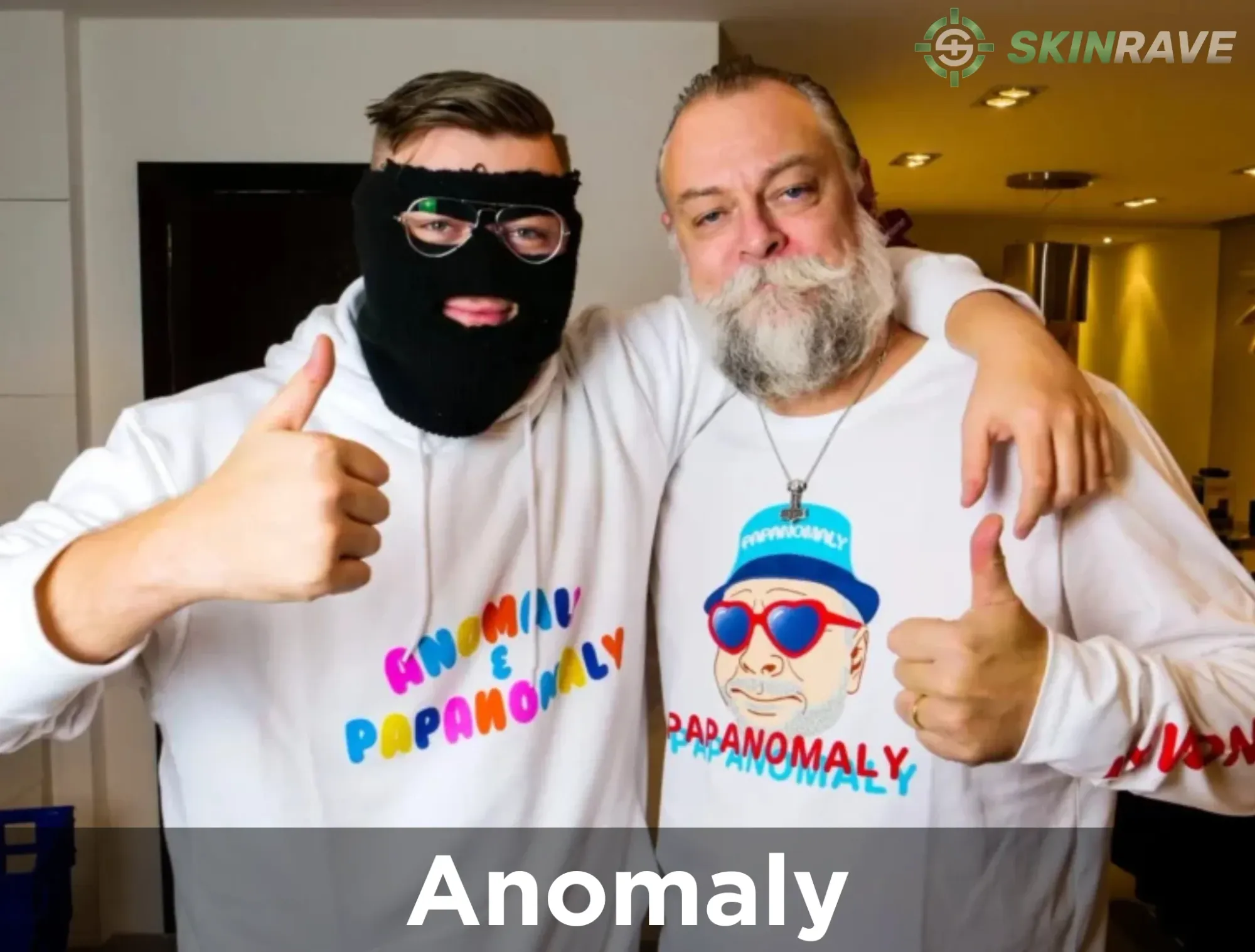 A photo of Anomaly with Papa Anomaly showing THUMBS UP with their merch on