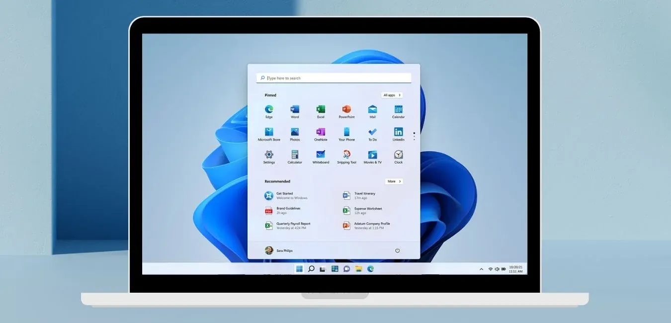 A MacBook displaying the Windows 11 Start menu, showing Boot Camp running Windows on a Mac