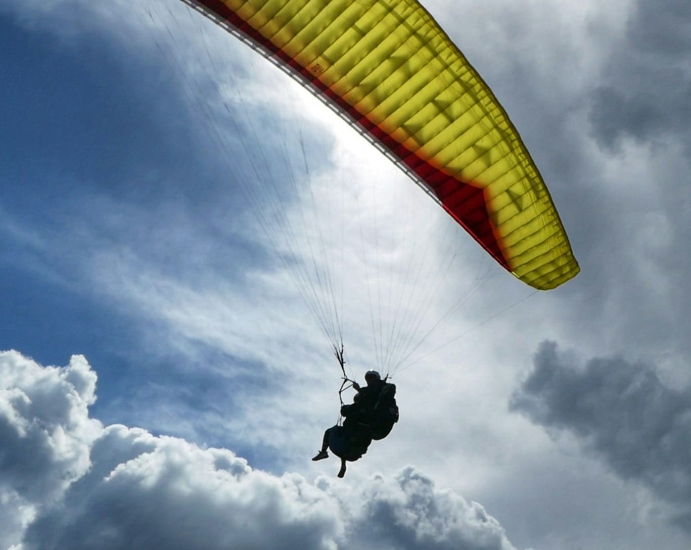 a person in the air with a parachute