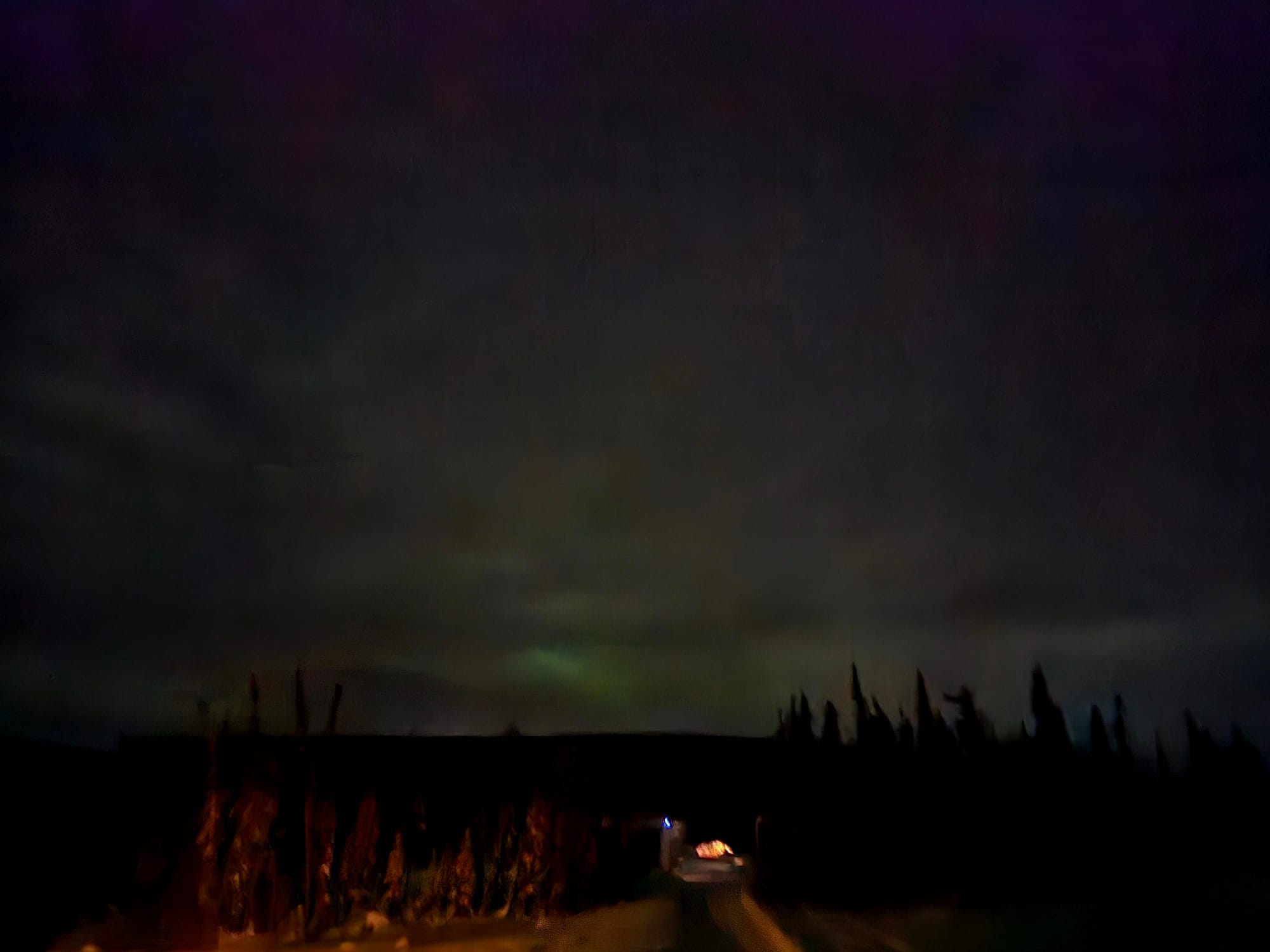 The aurora settling low on the horizon — less spectacle, more quiet presence — a reminder that not every display is dramatic, but each one is real.