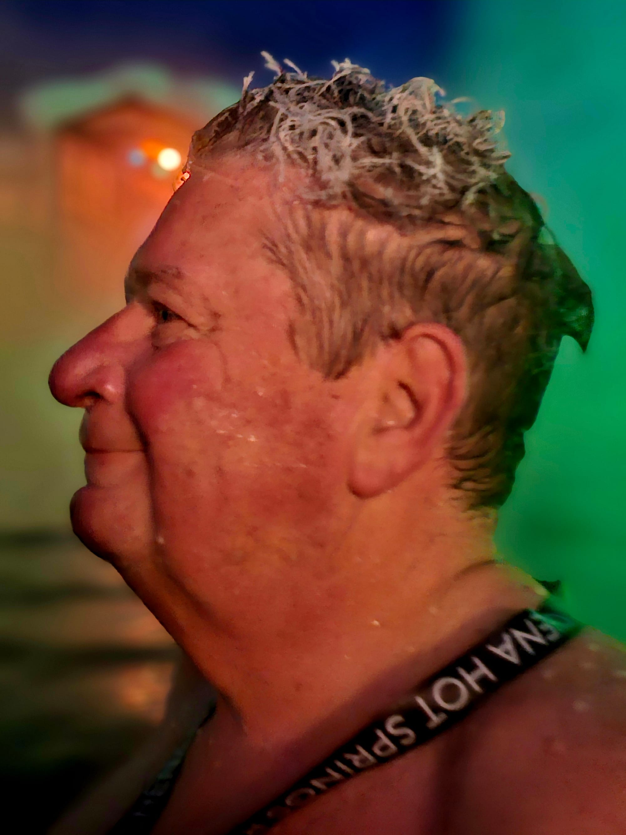 Ice hairstyle in progress at Chena Hot Springs Resort — wet your hair in 106°F water, lift it into subzero air, and it freezes solid while you’re still standing in the pool.