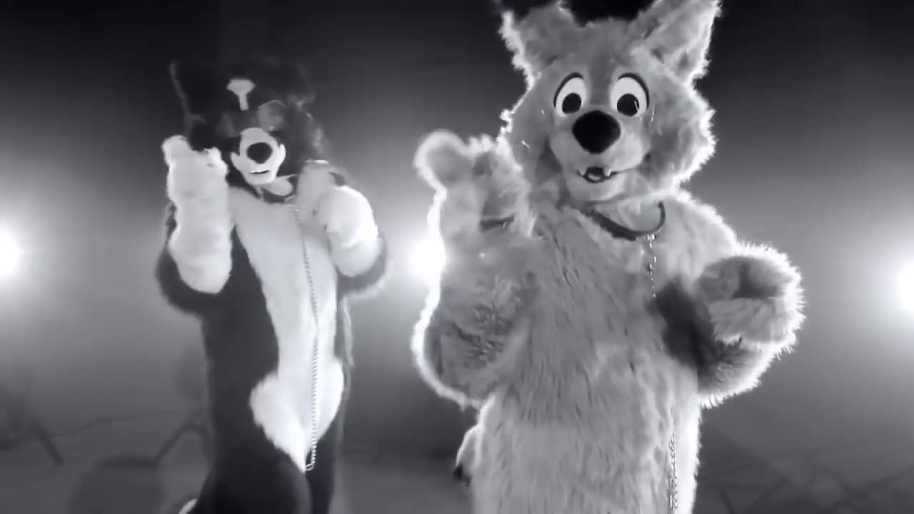 Two fursuiters standing in a sea of lights, both pointing at the camera with both paws. The black and white filter is meant to evoke the style of the music video of "All the Single Ladies" by Beyoncé.
