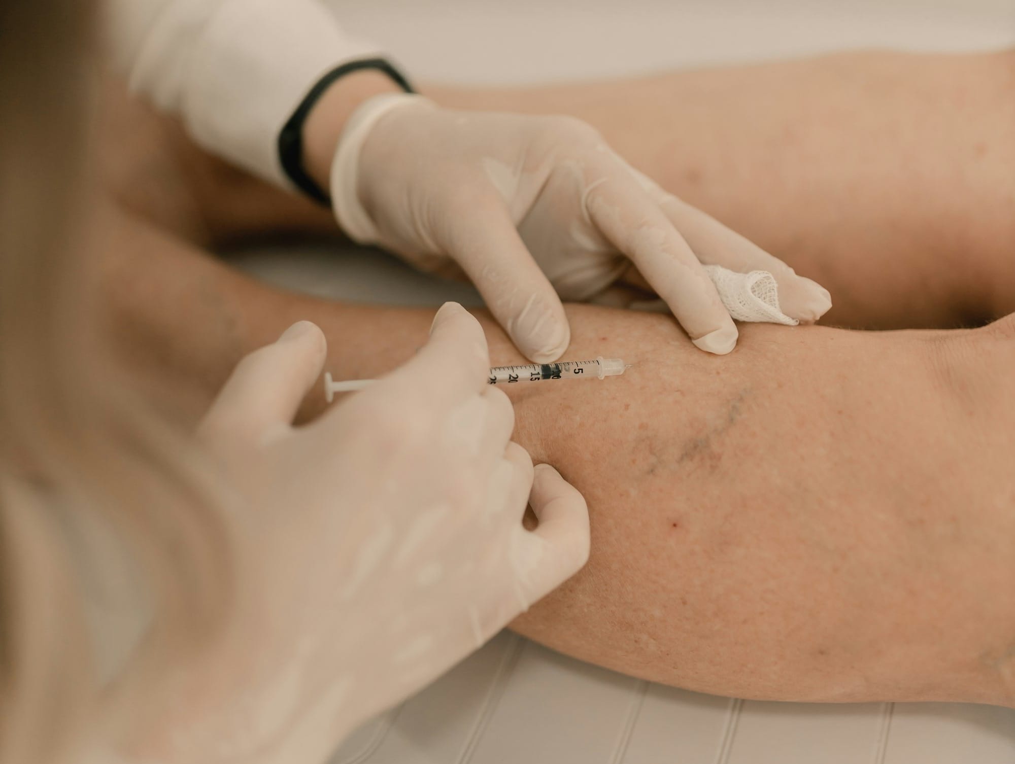 A woman getting her arm examined by a doctor
