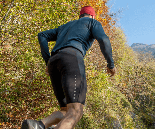 Man Athletic Cross-country training in the woods