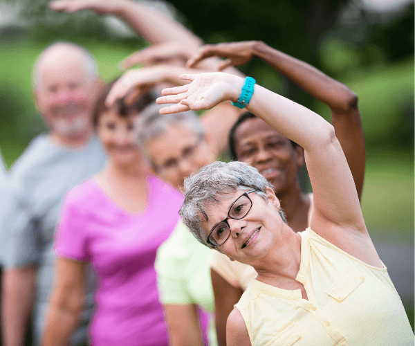 Seniors stretching in group exercise