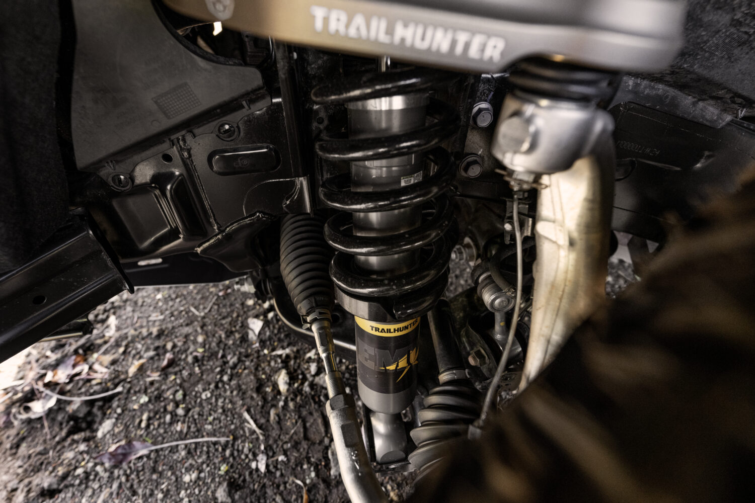 Close-up of Tacoma Trailhunter front suspension with Old Man Emu shock and coil spring.