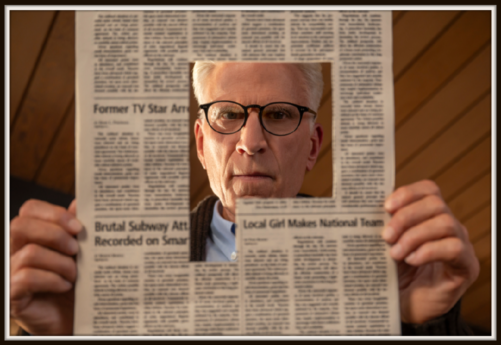 Ted Danson takes center stage in this gripping scene from A Man on the Inside, as his character holds a newspaper framing an intense moment. The subtle details in his expression highlight the depth of the storyline, showcasing Danson's impressive acting.